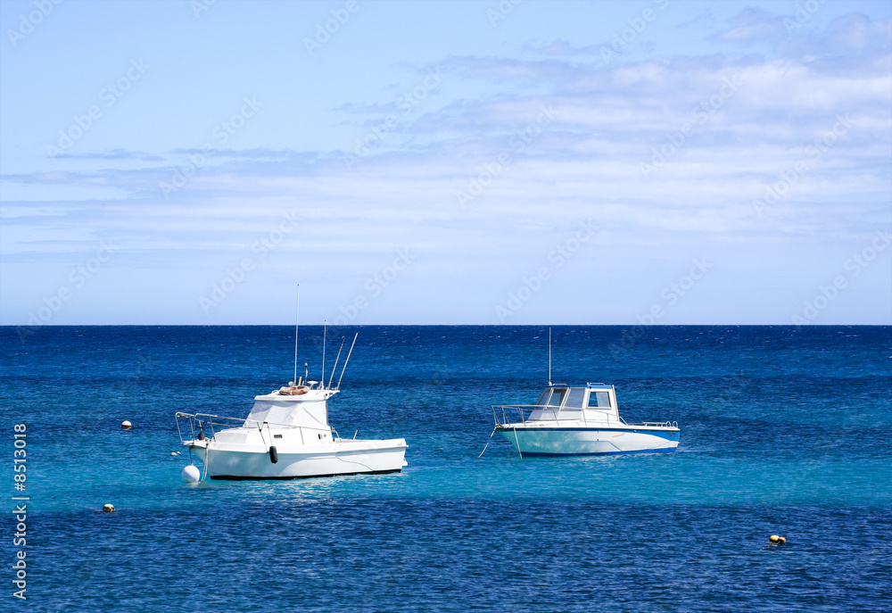 white motorboats on the sea