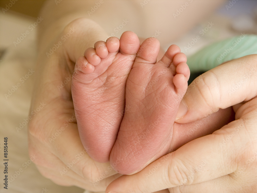 Mother holding her child's feet
