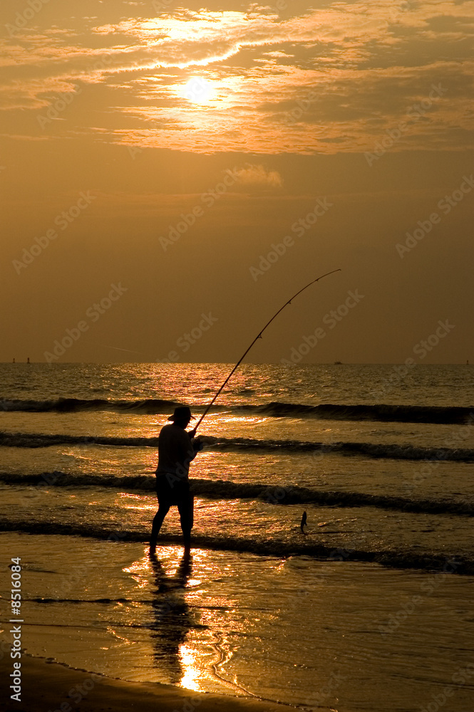 Fisherman Silhouettted in a Beach Sunrise