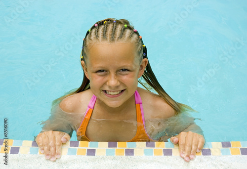 Young Girl Smiles at Poolside