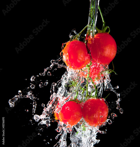 Flow of pourng water on tomato
