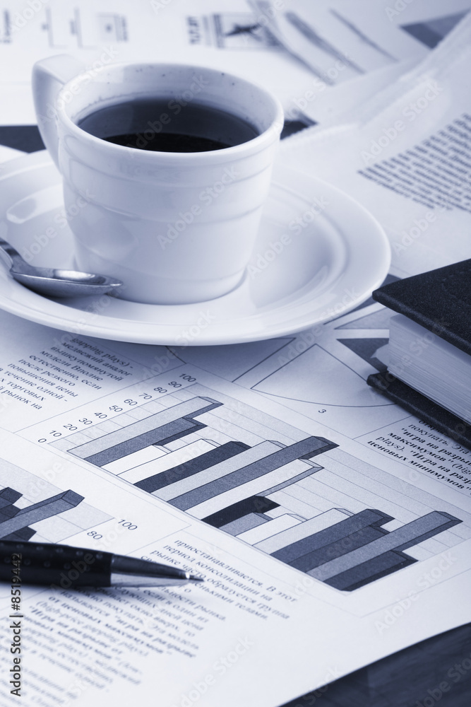 Cup of fragrant coffee on a morning paper business news Cup of fragrant coffee on a morning paper business news