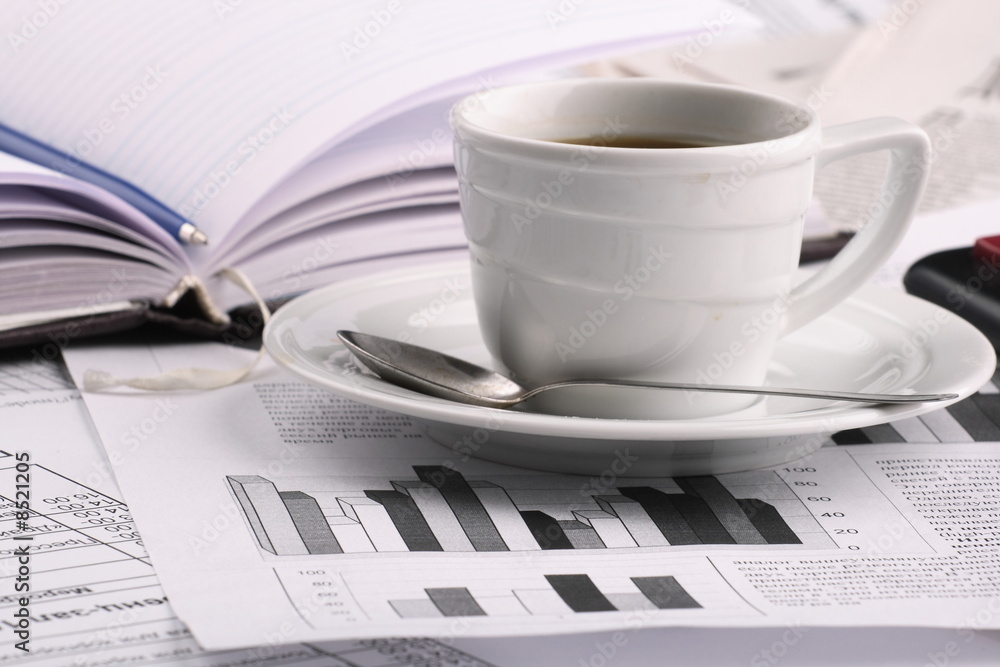 Cup of fragrant coffee on a morning paper business news Cup of fragrant coffee on a morning paper business news