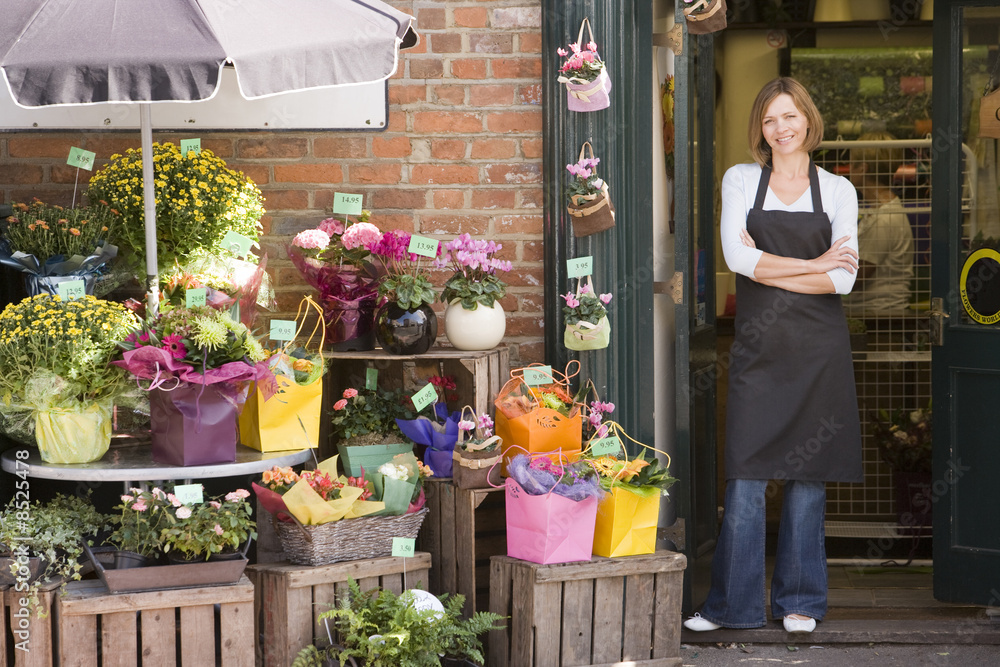 Woman working at flower shop smiling Woman working at flower shop smiling