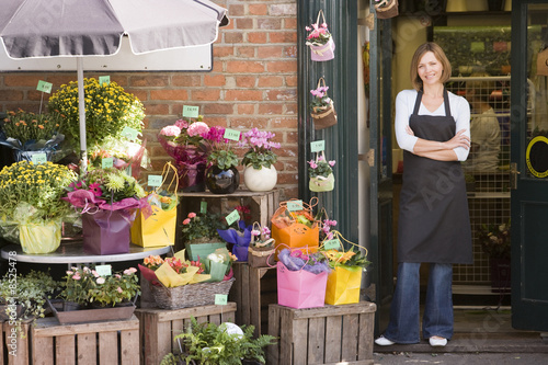 Woman working at flower shop smiling