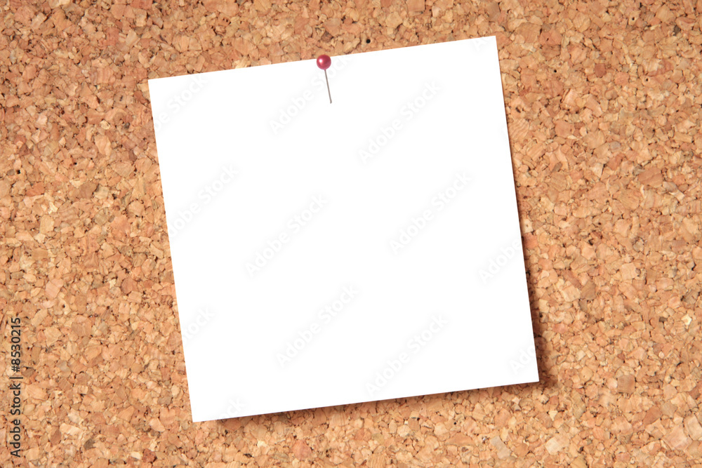 White blank card pinned to a brown cork board White blank card pinned to a brown cork board