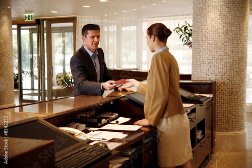 Photography Man checking in  at the hotel reception desk