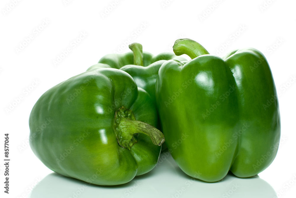 Three green sweet peppers