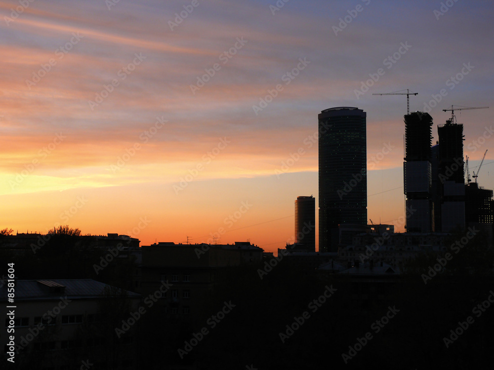 City. New houses in Moscow. A sunset.