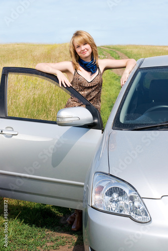 Girl standing near her car on the hill
