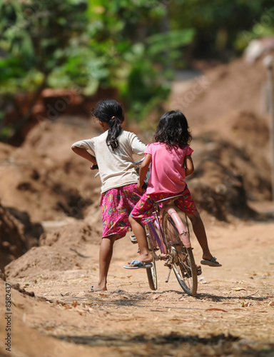 two cambodian kids on one bicycle