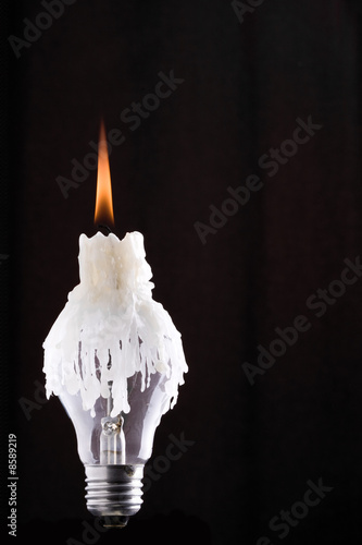 Lightbulb and burning candle