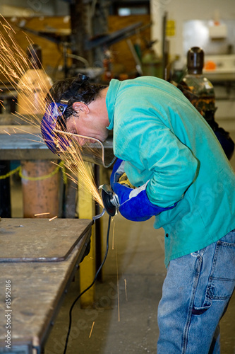 Metal Worker Using Grinder photo