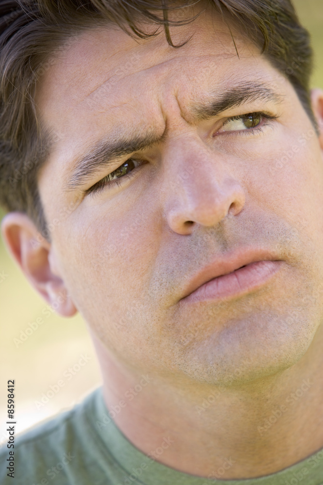 Obraz premium Head shot of man scowling