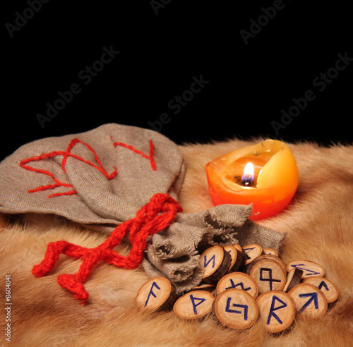 Runes, pouch and candle with copy space