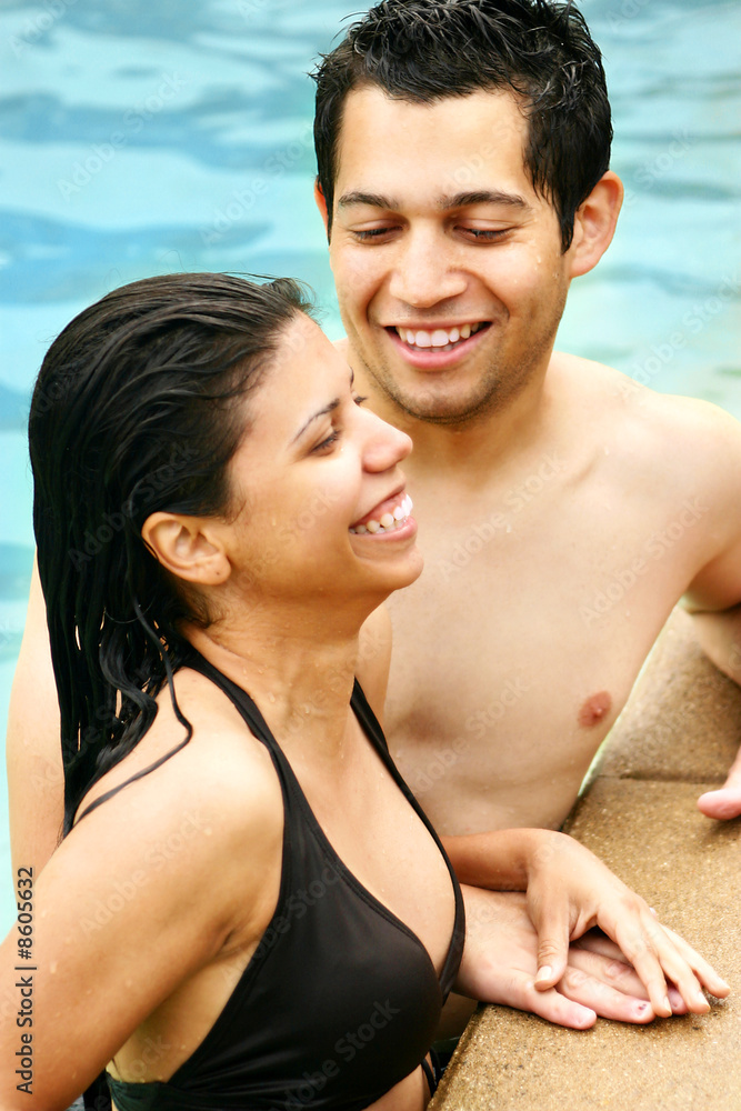 Young Couple Talking in a Swimming Pool Young Couple Talking in a Swimming Pool