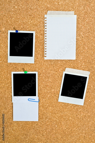 Cork board with blank instant photos and notes