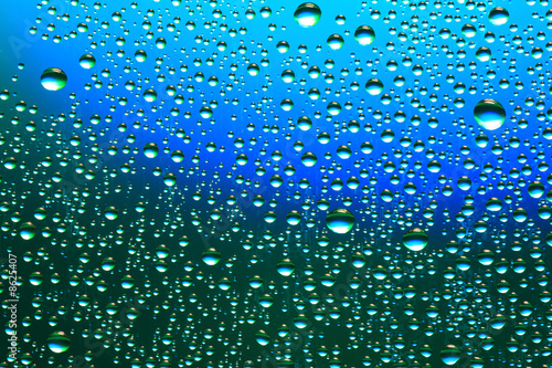 Drops of water on a blue  green background.