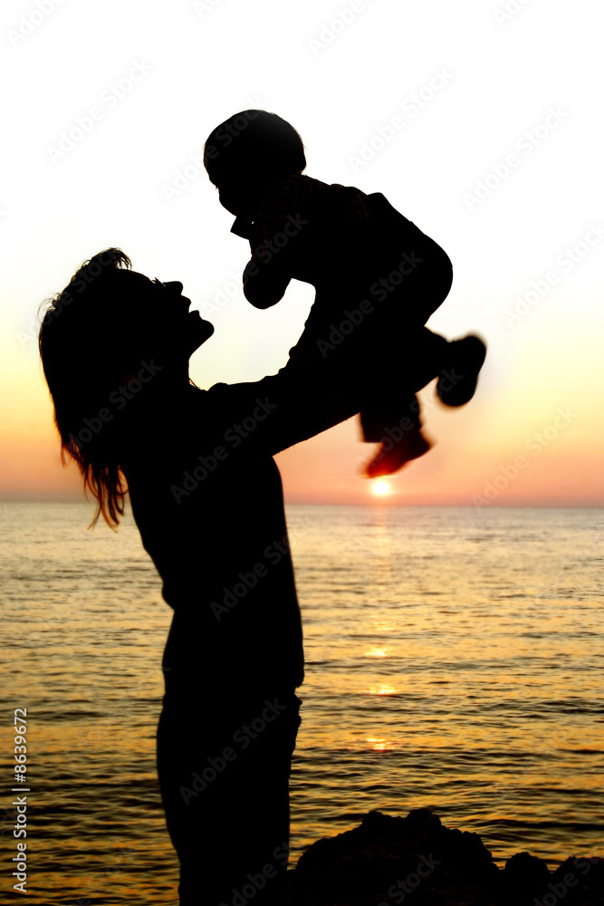 silhouettes of mother and son partly isolated over white