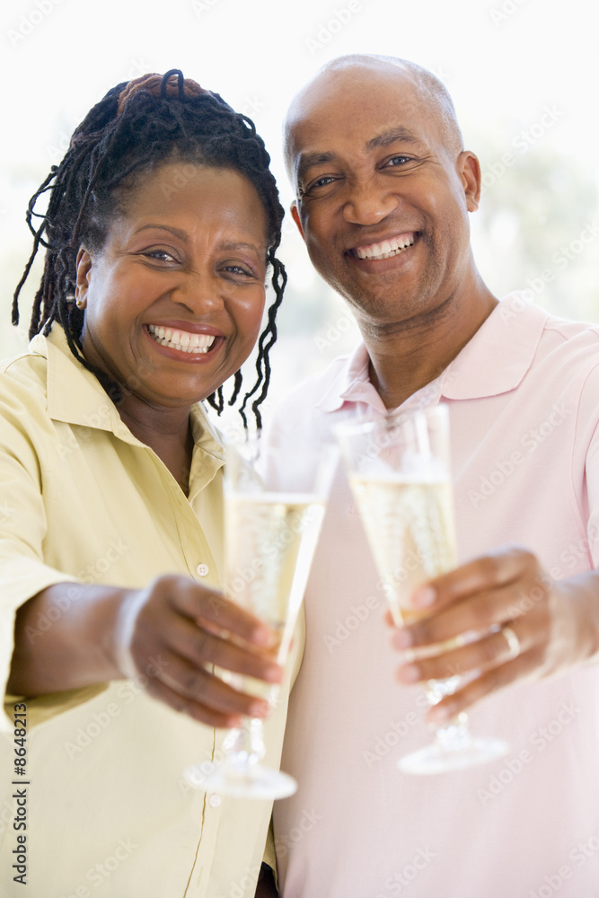 Couple toasting champagne and smiling Couple toasting champagne and smiling