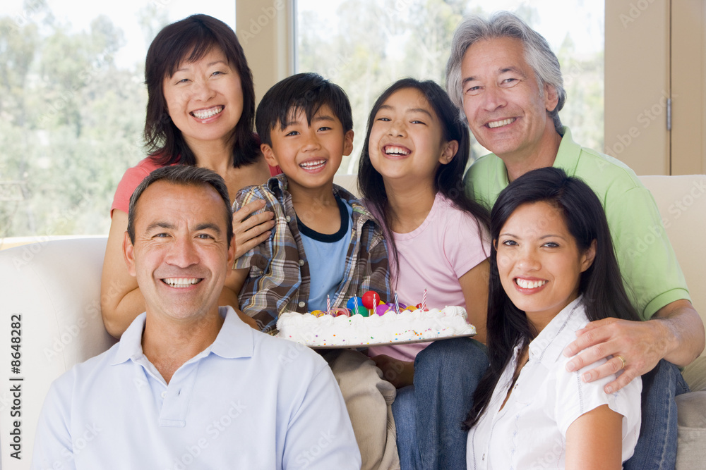 Obraz premium Family in living room with cake smiling