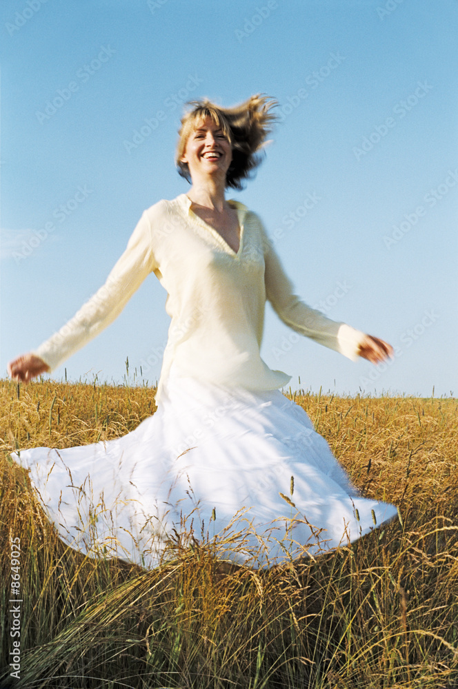 Woman spinning outdoors smiling