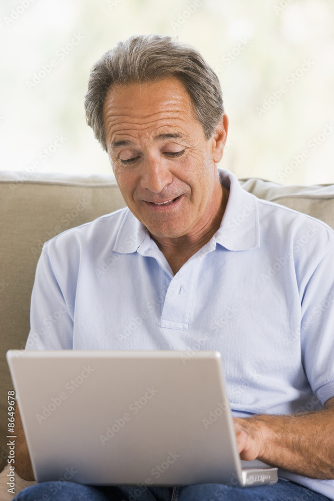 Man in living room with laptop Man in living room with laptop