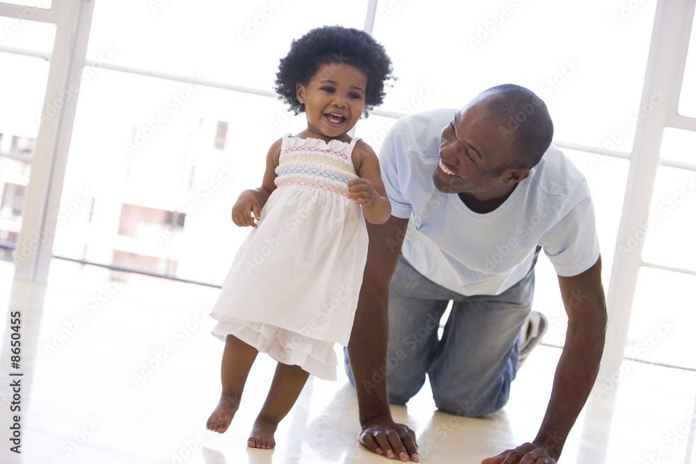 Father and daughter indoors playing and smiling Father and daughter indoors playing and smiling