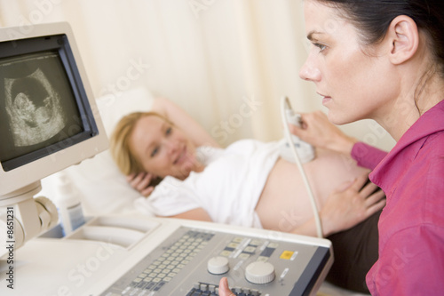 Pregnant woman getting ultrasound from doctor © Monkey Business