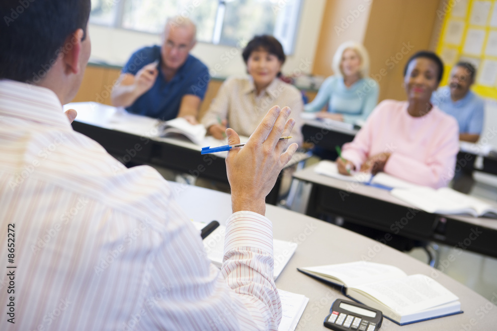 Mature students and their teacher in a classroom Mature students and their teacher in a classroom