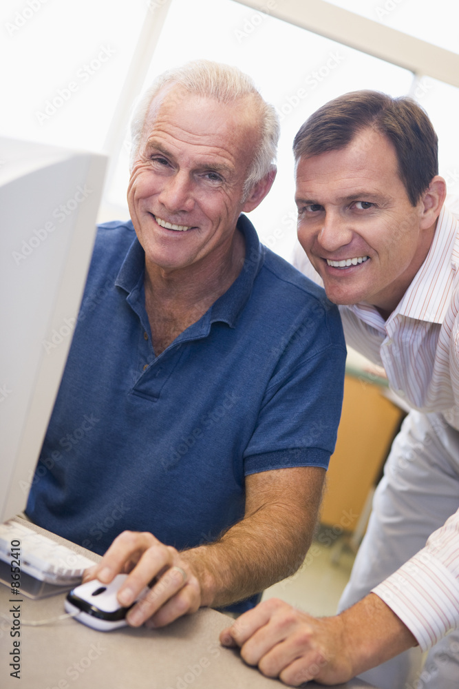 Mature male student learning computer skills Mature male student learning computer skills