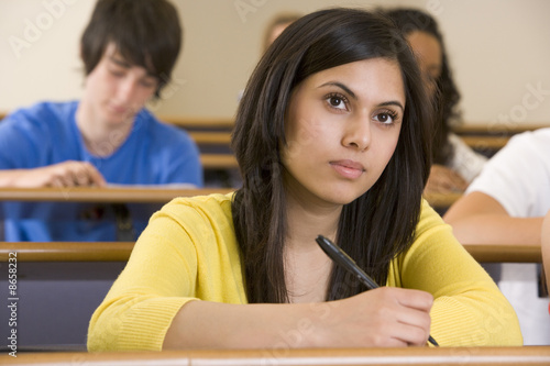 Female college student listening to a university lecture