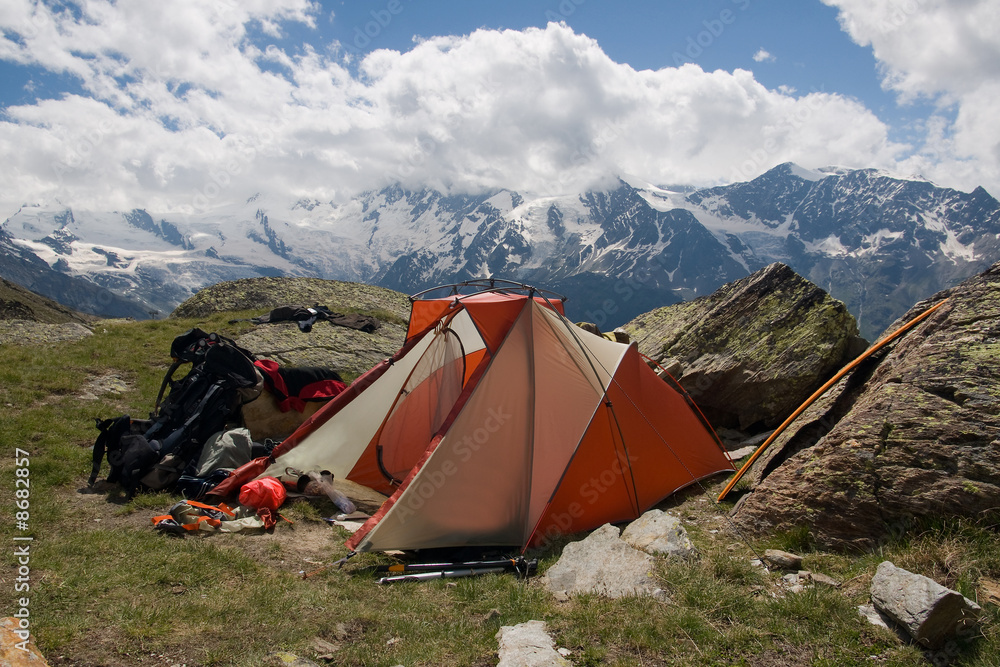 Orange tent in summer mountains