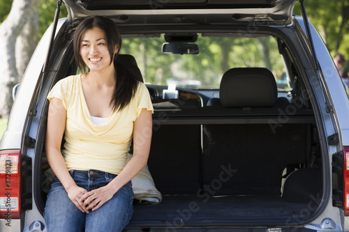 Woman sitting in back of van smiling © Monkey Business