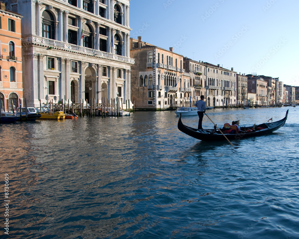 Gondolier in the Grand Canal with wo passengers