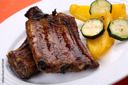 Tasty grilled ribs with vegetables photo