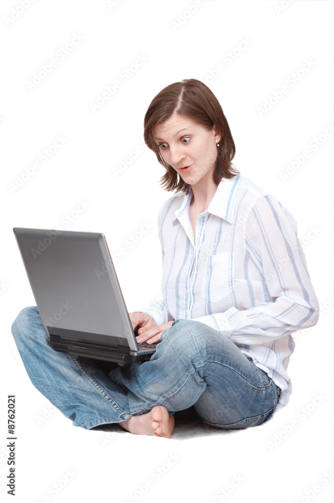 amazed woman with laptop sitting on the floor amazed woman with laptop sitting on the floor
