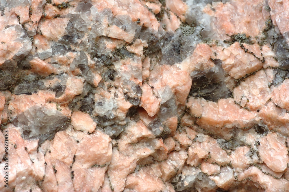 Texture of stone consisting of white and pink quartz