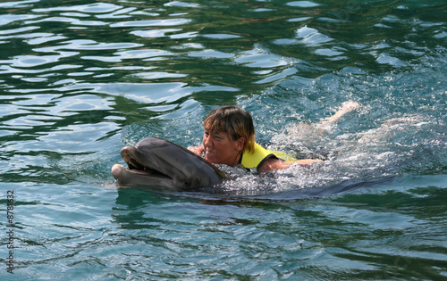 girl swimming with dolphin