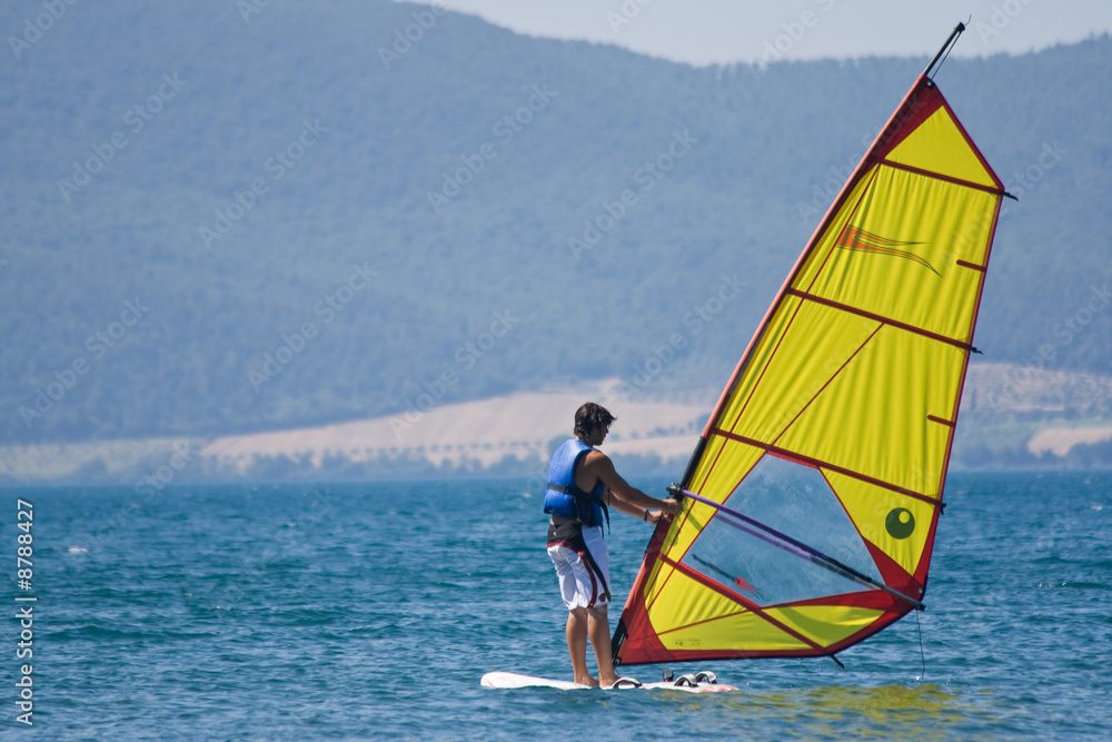 Naklejka premium Surfing windsurfer Bracciano lake Italy