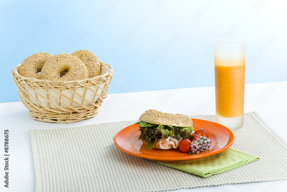 Breakfast bagels on the kitchen table over blue background