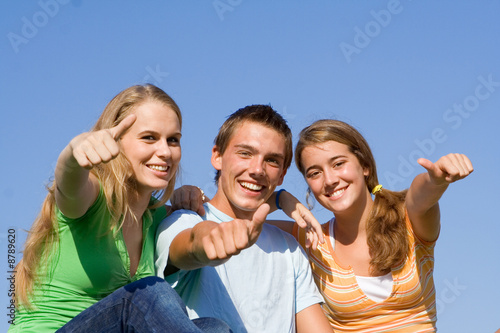 happy smiling group of teens with thumbs up