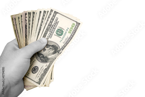 A handful of cash isolated over a white background.