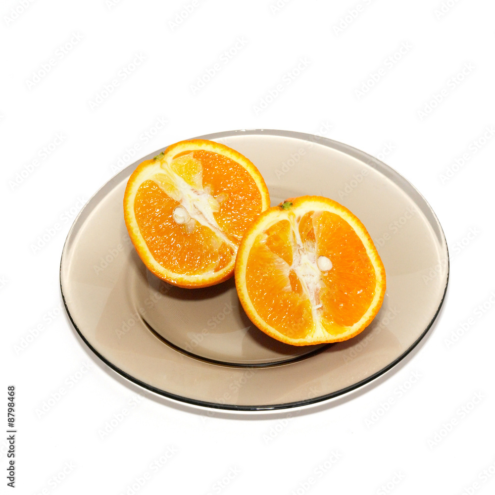 Orange segments on the plate isolated on white. Orange segments on the plate isolated on white.
