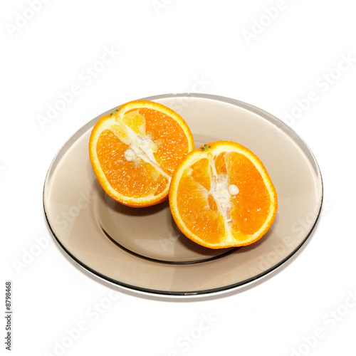 Orange segments on the plate isolated on white.