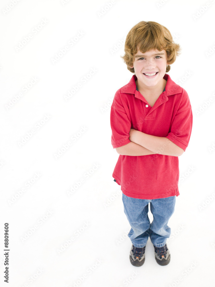 Young boy with arms crossed smiling Young boy with arms crossed smiling