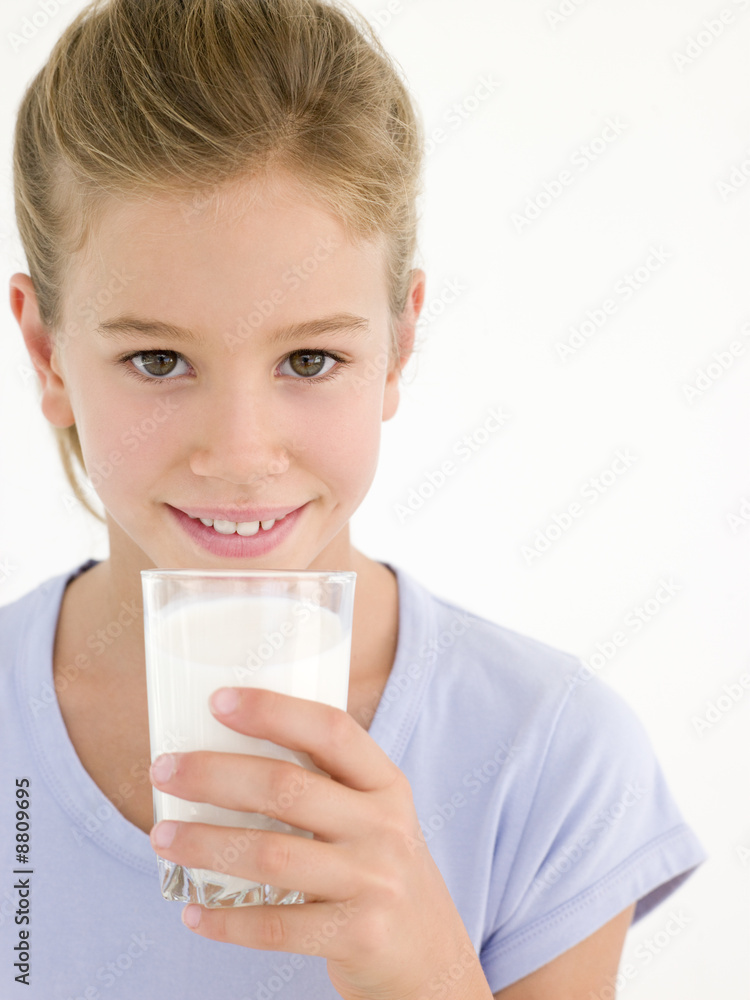Young girl with glass of milk smiling Young girl with glass of milk smiling