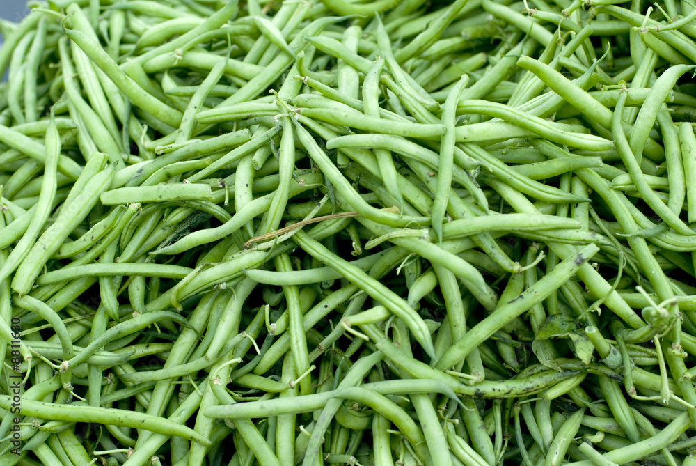 Long green beans heaped at a market.. Long green beans heaped at a market..