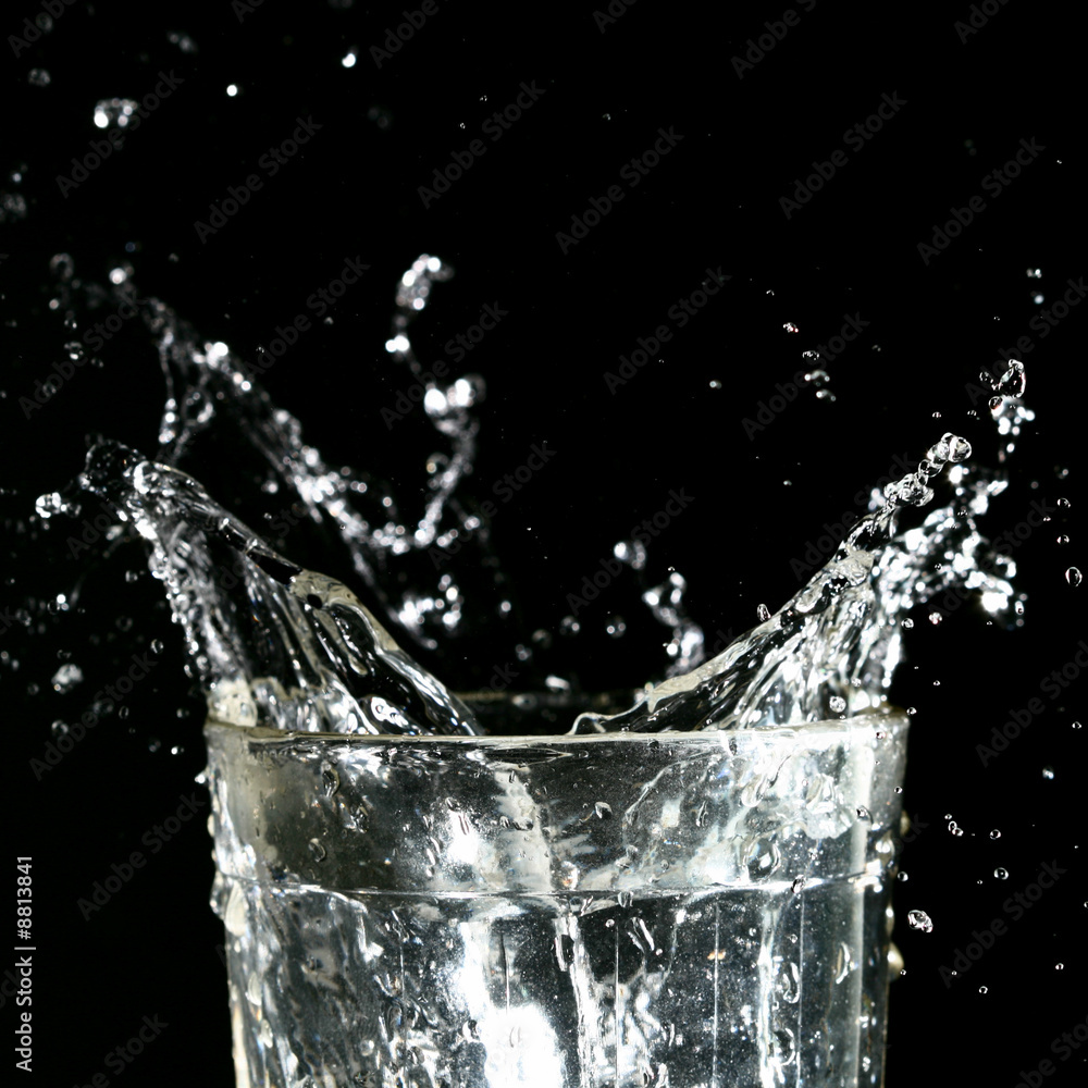 splash in glass on dark background splash in glass on dark background
