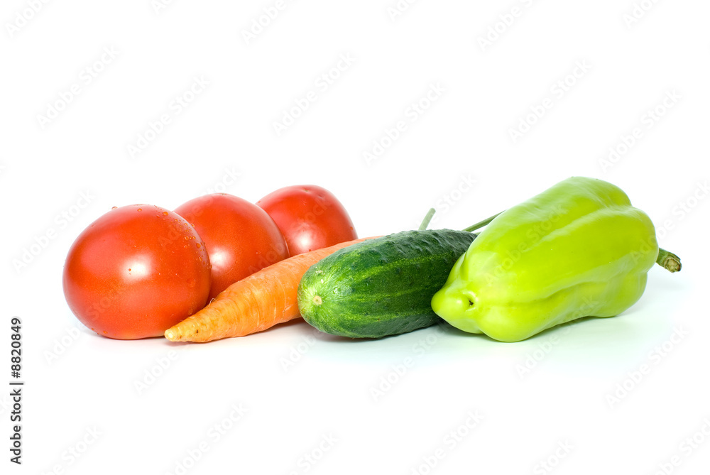 Tomatoes, carrot, cucumber pepper isolated on the white Tomatoes, carrot, cucumber pepper isolated on the white